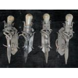 A set of four wrought iron wall scones, fitted for electricity, 37cm high excluding bulb (4)