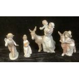 A Lladro figure group, Mother and Child with Donkey; another, Boy embrassing Donkey; others (4)