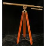 A reproduction brass telescope on tripod stand