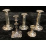 A pair of Edwardian silver candlesticks, 13.5cm high, Birmingham 1905; other silver candlesticks;