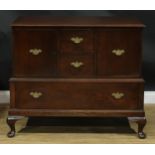 An oak side cabinet, rectangular top above an arrangement of drawers and doors, cabriole legs, pad