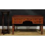 A Victorian mahogany desk, slightly oversailing top above an arrangement of drawers, turned legs,