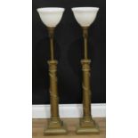 A pair of 'gilt' metal architectural table lamps, each as an anthemion capped lotus grasped