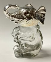 A contemporary silver plated and glass novelty jar and cover, in the form of an elephant, glass