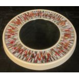 A Piaggi Roulette circular looking glass, the central mirror plate framed by a multicoloured