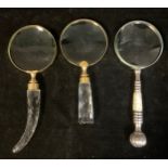 A collection of three magnifying glasses, various decorative handles, the largest 26.5cm long (3)