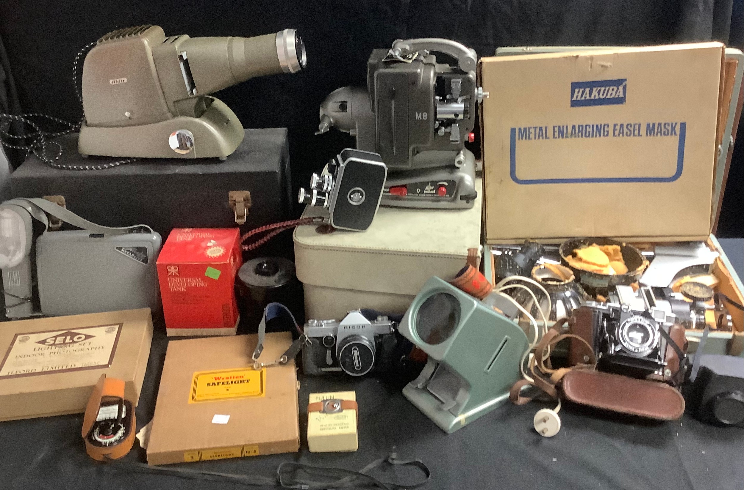 A Zeiss Ikon 35mm camera, brown leather case; a Ricoh Singlex TLS 35mm camera, a Kodak Brownie, a