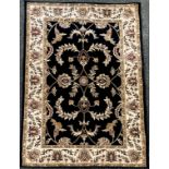 A Dunelm Mill woollen rug, Legacy, black ground, 160cm x 230cm