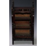 An early 20th century mahogany cigar cabinet, the rectangular glazed door enclosing three sliding