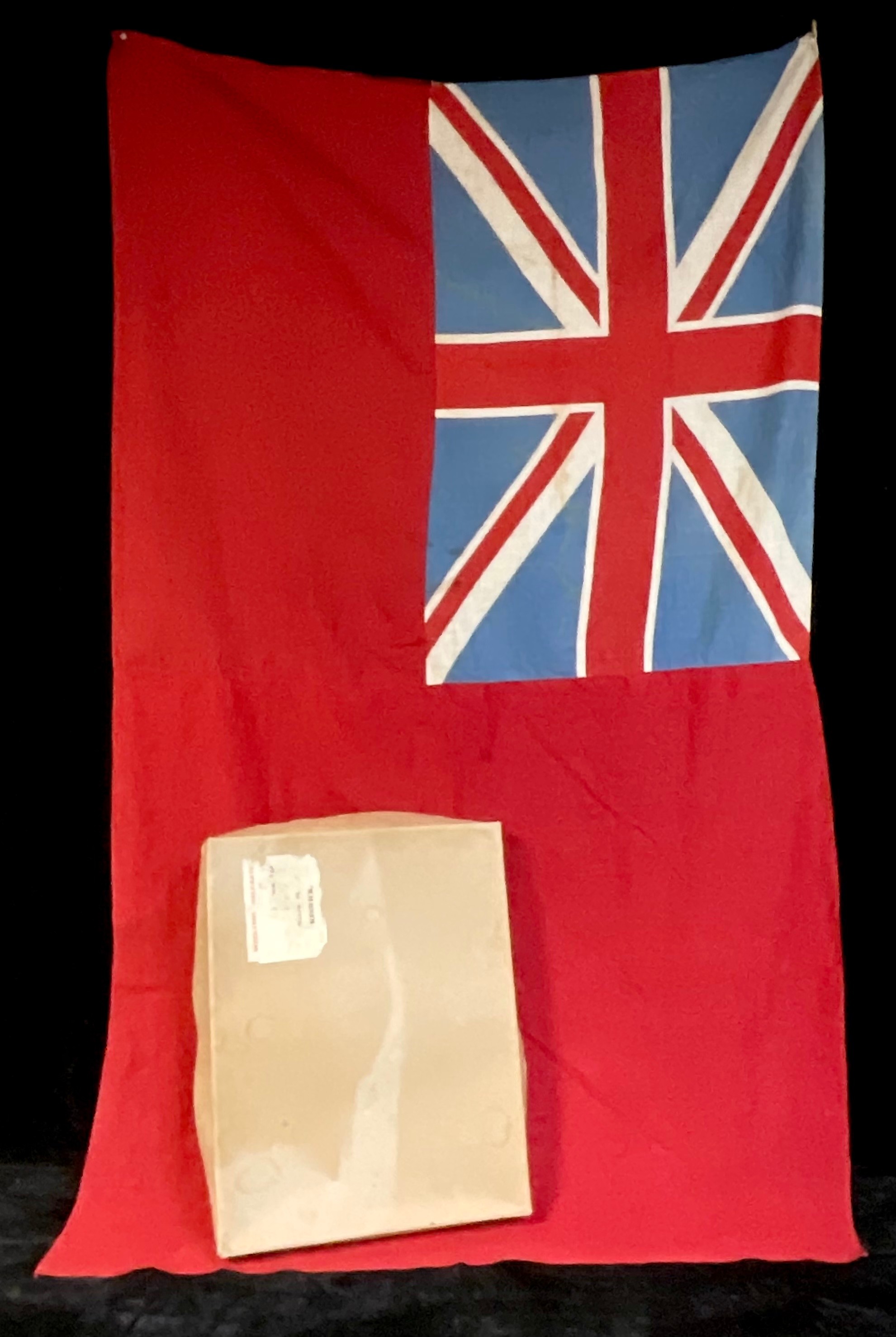 A British Naval red ensign flag, boxed - the box lid with label for Woollens of Keswick