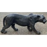 A resin garden statue of a black panther, 36.5cm high, 85cm long