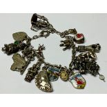 A silver charm bracelet, with eighteen silver and silver coloured metal charms