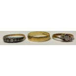 An 18ct gold wedding band, size R, marked 750, 2.4g; two 18ct gold illusion set diamond rings, 4.