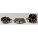 A 14ct gold ring, set with an arrangement of nine blue stones, four diamond chips, one to each
