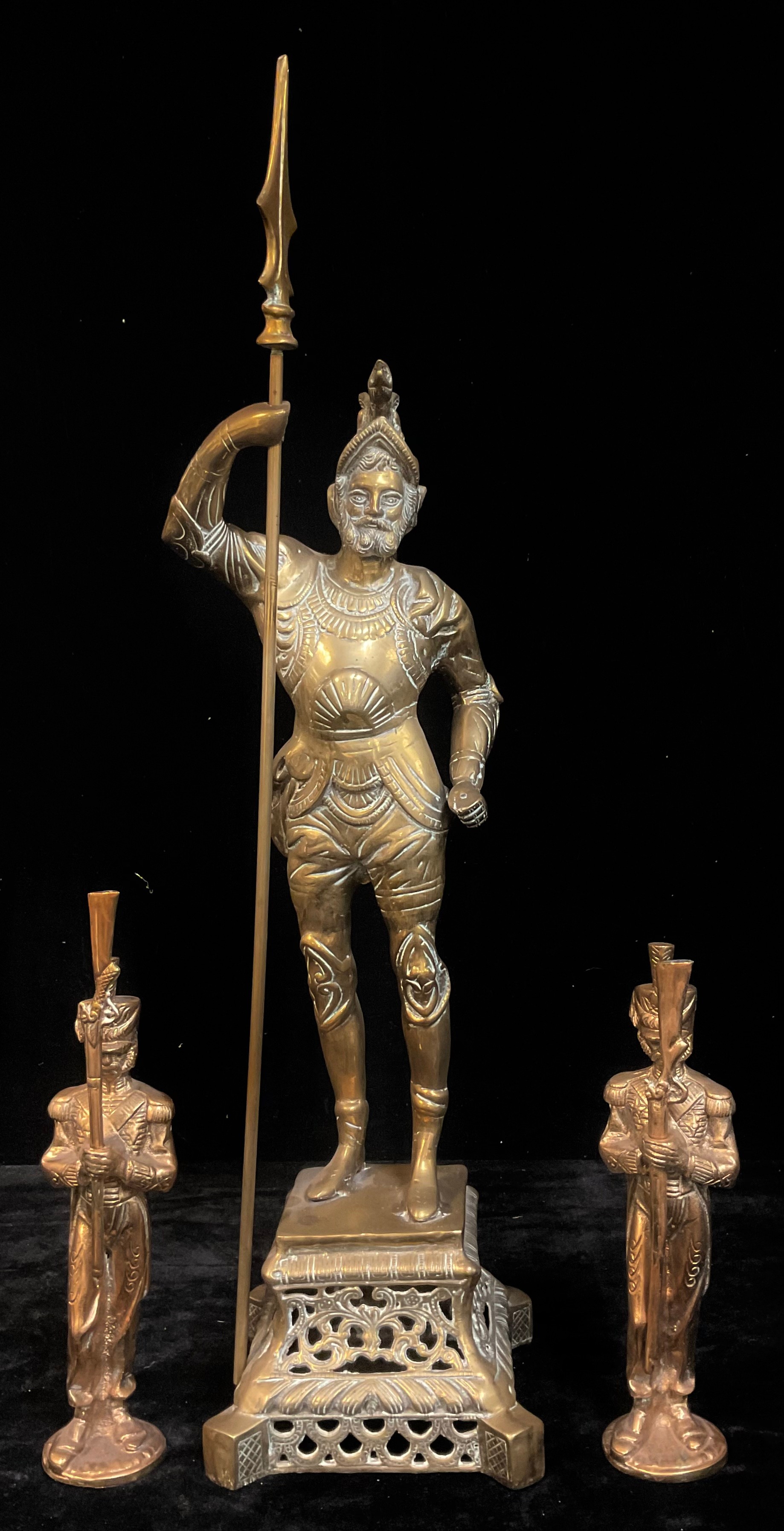 A brass floor standing fireside companion, as a 16th century chivalric knight, standing as a