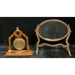 A late 19th century Gothic oak and brass dinner gong with beater, 33cm; an early 20th century