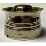 An Edwardian silver inkwell, hinged domed cover, three pen apertures, glass lined, 9cm diameter,