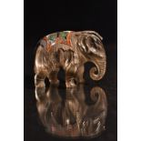 A carved rock crystal enamel and metal elephant, carved standing with ornate cast and enamelled base
