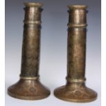A pair of large Middle Eastern Islamic brass mosque candlesticks, pierced and engraved with a