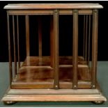 An Edwardian mahogany table top revolving bookcase, moulded edge, four compressed bun feet,34.5cm