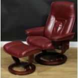 An Ekornes red Paloma leather Stressless recliner consul chair, medium size, 101cm high, 77cm