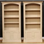 A pair of painted pine open bookcases, each 202.5cm high, 100.5cm wide, 32.5cm deep (2)