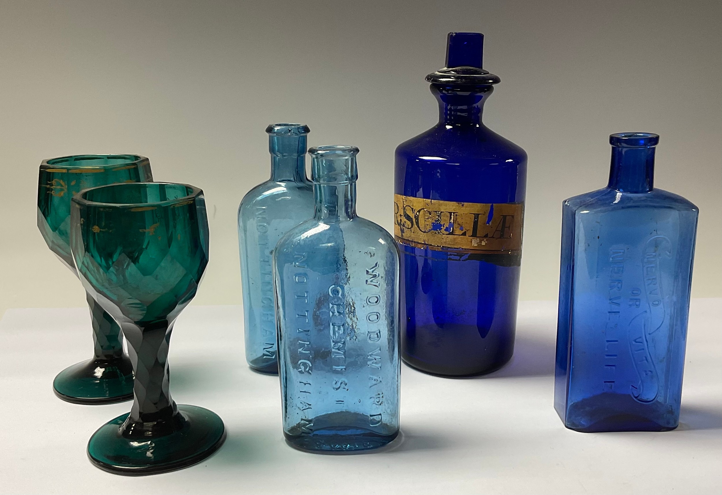 A 19th century blue glass apothecary bottle, gilt label SYR.SCILAE, 20cm high; a pair of 19th