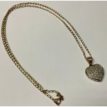 A 9ct gold diamond set heart shaped pendant and chain