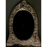 A Victorian style silver oval shaped easel dressing table mirror, the border with embossed