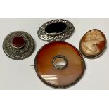 A Scottish silver and agate brooch; two silver and agate brooches; a cameo brooch (4)