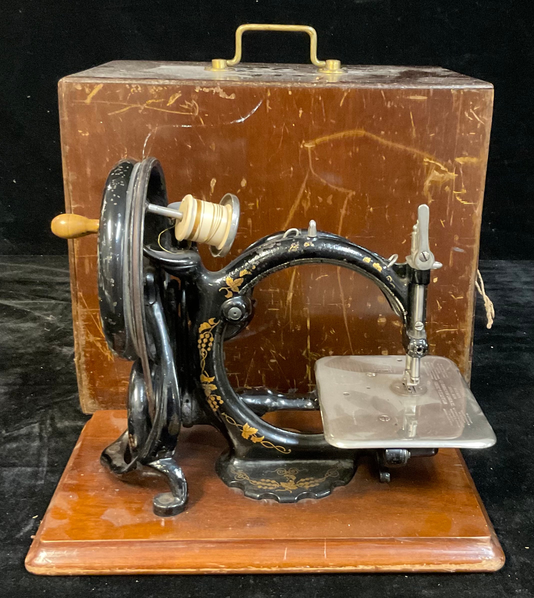 A late 19th century Wilcox & Gibbs hand cranked C-frame sewing machine, cased