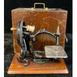 A late 19th century Wilcox & Gibbs hand cranked C-frame sewing machine, cased