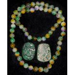 A pair of jade pendants; a string of jade beads (3)