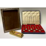 A rectangular silver photograph frame, Birmingham; a set of eight silver Coronation 1937 spoons,