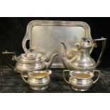 A silver plated four piece boat shaped tea service, on a planished pewter two handled tray (5)
