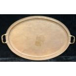 A large Canadian Arts and Crafts planished brass and copper oval two-handled tray, Paul Beau and Co,