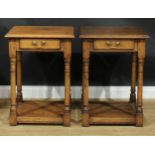 A pair of oak side or lamp tables, possibly by Titchmarsh & Goodwin, each with moulded top above a