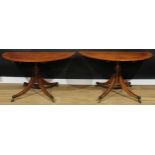 A pair of Regency mahogany demilune pedestal tables, formerly the end sections of a multiple