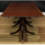 A Regency style triple-pillar dining table, rounded rectangular top with two additional leaves,