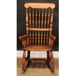 A country cottage rocking chair, 106.5cm high, 57.5cm wide, the seat 40cm wide and 35cm deep