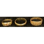 An 18ct gold wedding band, size O, marked 750, 3.9g; two 18ct gold rings, 6.5g (3)