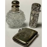 A Victorian silver cylindrical smelling salts bottle, hinger cover, drop-in glass stopper, chased