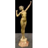 An Art Deco style brass figure, female nude on tiptoes mid stretch, angular onyx base, 55cm