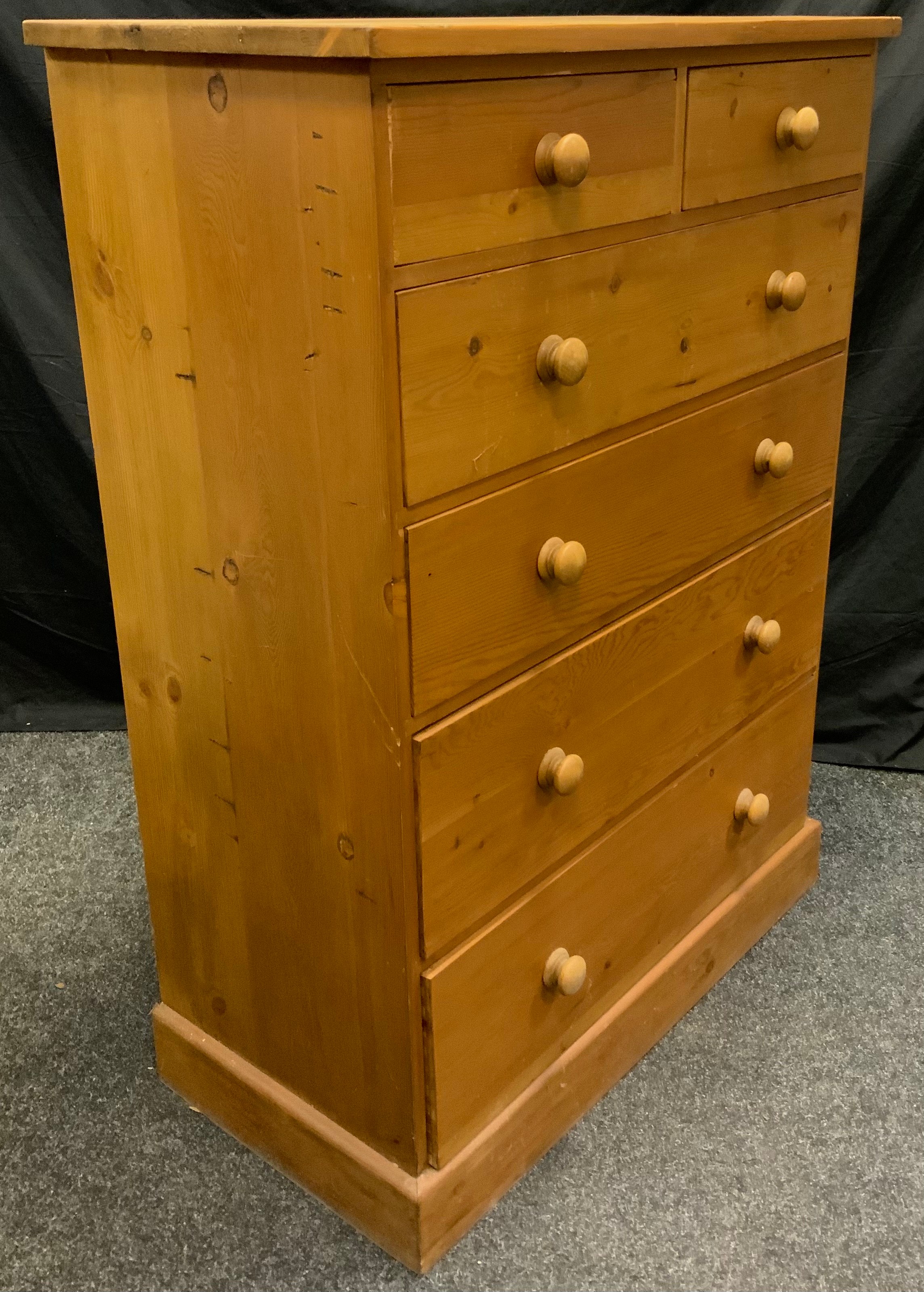 A 20th century pine chest of drawers, two short over four graduated long drawers, turned handles,