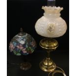 A Tiffany style leaded glass table lamp, the shade with dragonflies amongst lilies 37cm tall; a
