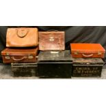 A vintage leatherette suitcase; another smaller; satchels. black document boxes etc (7)