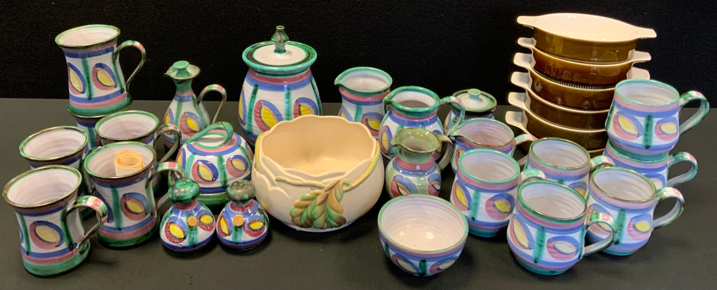 A Clarice Cliff moulded Newport pottery fruit bowl; Tintagel studio pottery cups,. jugs, butter dish