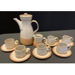 A Winslow studio pottery coffee set, for six, mottled in tones of grey and brown, impressed marks