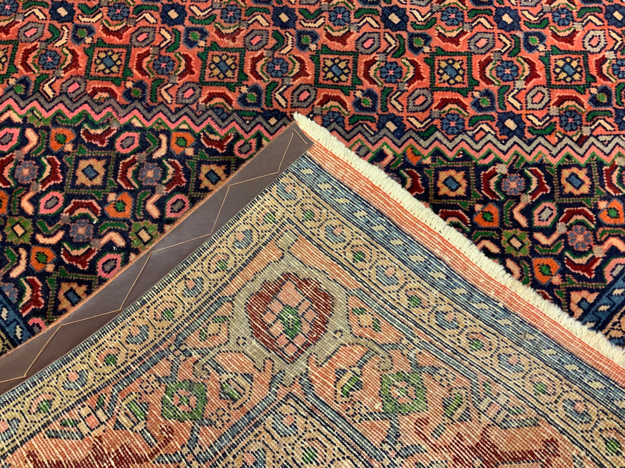 A Persian rug / carpet, hand-knotted with a central hexagonal form medallion within a field of - Image 2 of 2