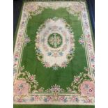 An Indian hand-made carpet / rug, in green, blue, and cream, 412cm x 280cm.